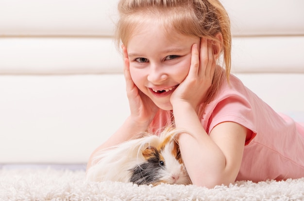 Little with peruvian guinea pig