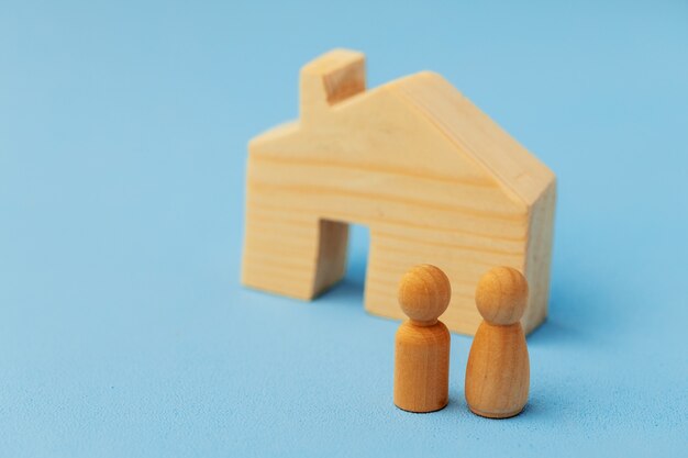 Little wooden men and house miniature close up photo