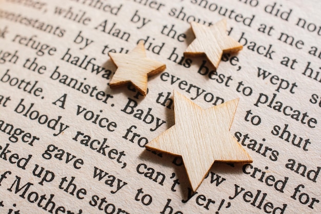 Photo little wooden stars on book page