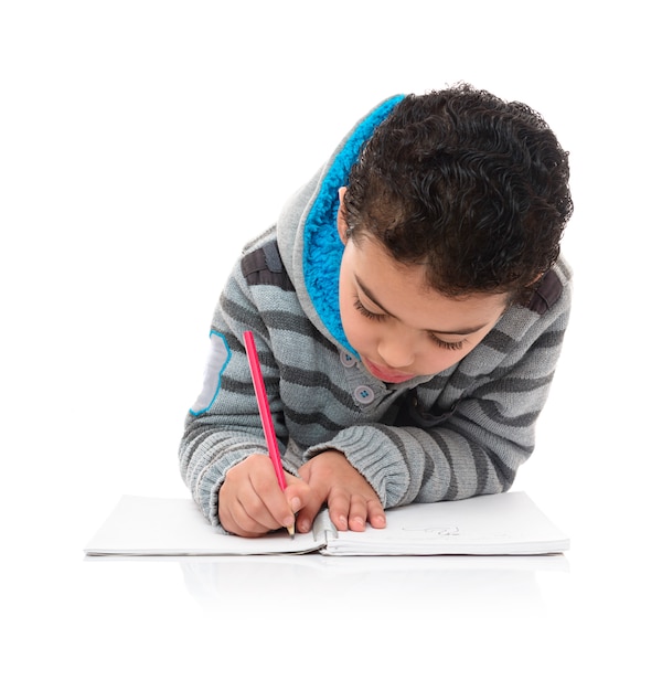 Photo little young schoolboy studying hard isolated