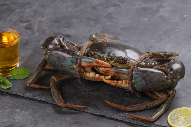 Live mud crab arranged on a slate or graphite sheet