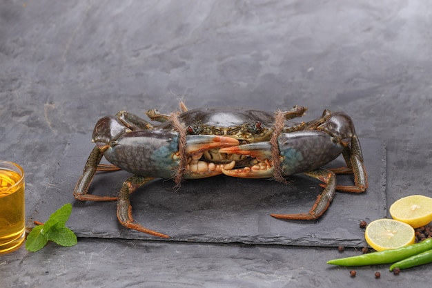 Live mud crab arranged on a slate or graphite sheet