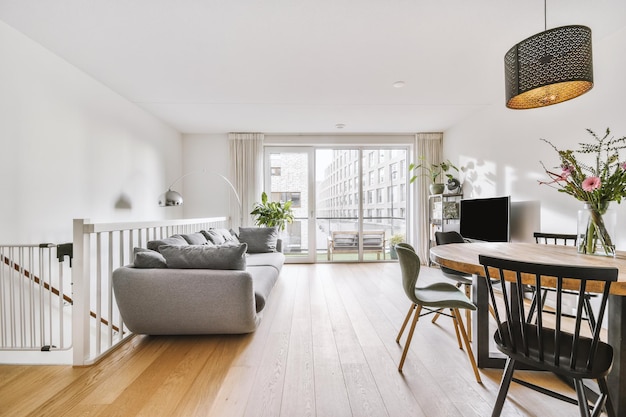 A living room combined with a dining area on the wooden floor of a modern cozy house