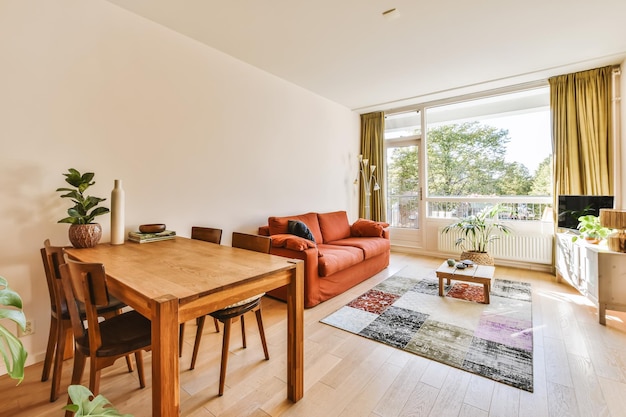 A living room and dining room with a large window