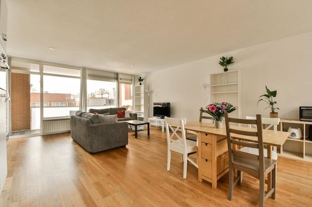 A living room and dining room with a large window