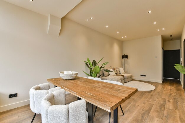 a living room and dining room with a wooden table