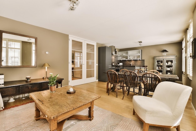 Photo a living room and kitchen area in a house with wood floors white walls hardwood flooring and large windows