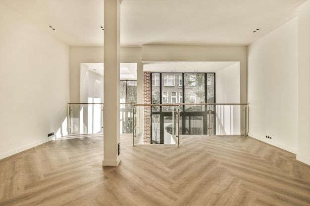 A living room with a balcony and hardwood floors