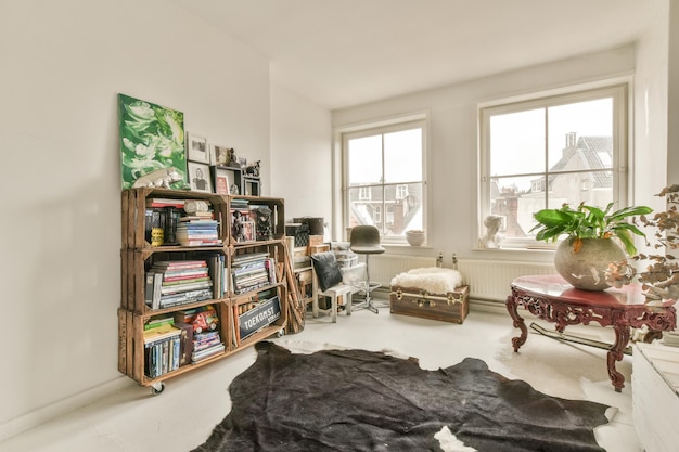 A living room with a book shelf and a rug