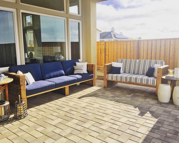 a living room with a couch and a couch with a large pillow on it