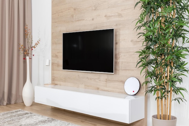 Living room with couch and led tv on wooden wall