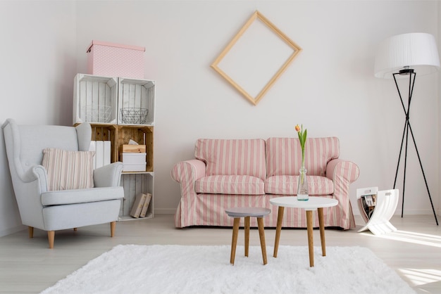 A living room with a couch and a table with a lamp on it.