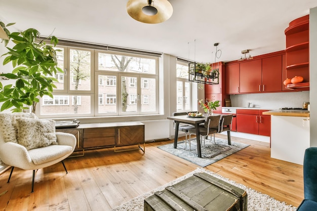 A living room with a dining table and a kitchen