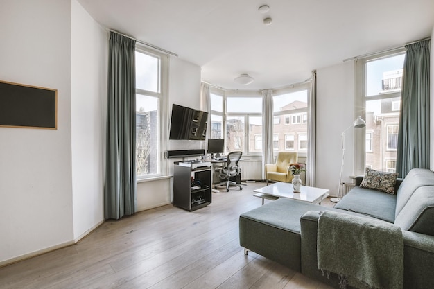 Living room with gray sofa and workspace