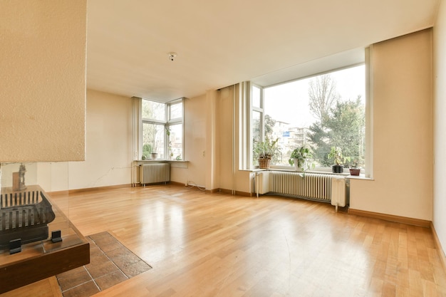 A living room with a large window and wooden floors