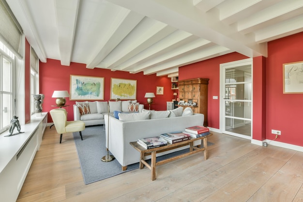 A living room with red walls and a white couch