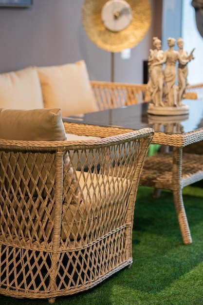 A living room with a table and chairs and a table with a statue of the goddess of the sea