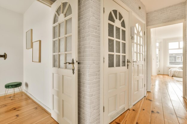 a living room with white doors and a brick wall