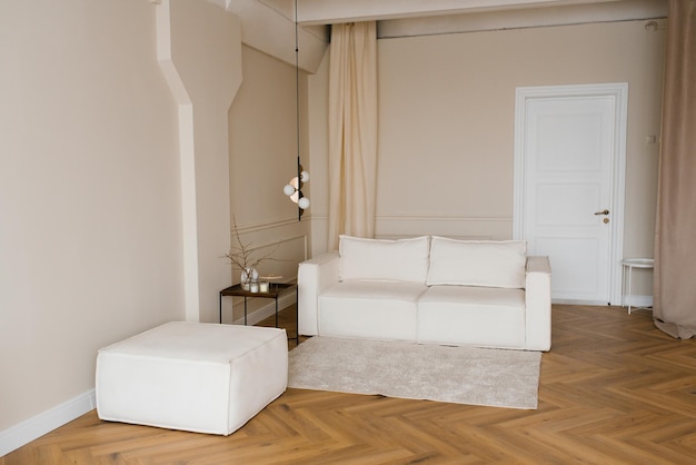 A living room with a white fabric sofa and a coffee table Minimalist Scandinavian interior design with lamp and carpet