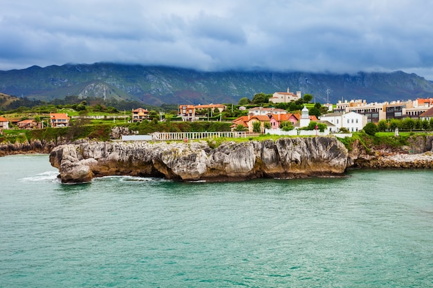 Llanes Port lighthouse and city aerial view. Llanes is a municipality of the Asturias province in northern Spain.