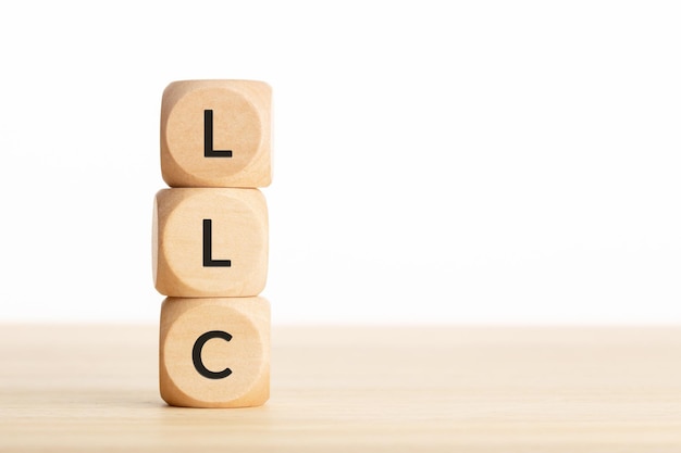 LLC or Limited Liability Company concept Tex on wooden blocks on table Copy space