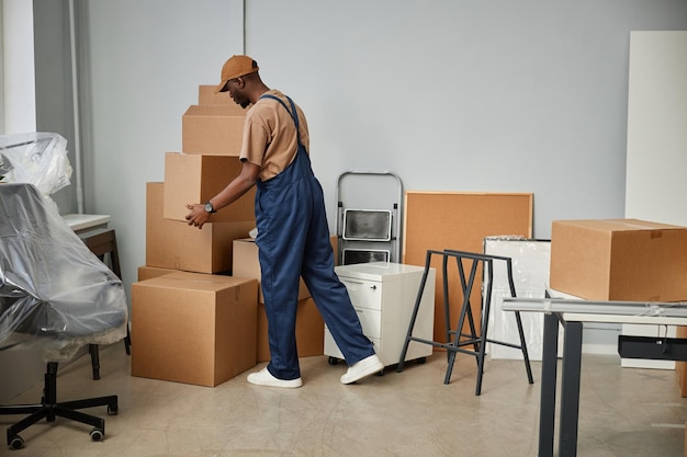 Photo loader carrying boxes in new office