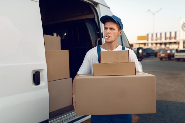 Loader holding stack of parcels, delivery service