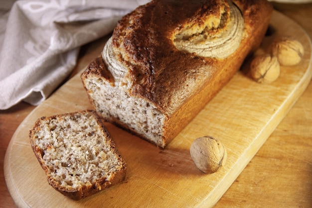 A loaf of banana bread with a nut on the side