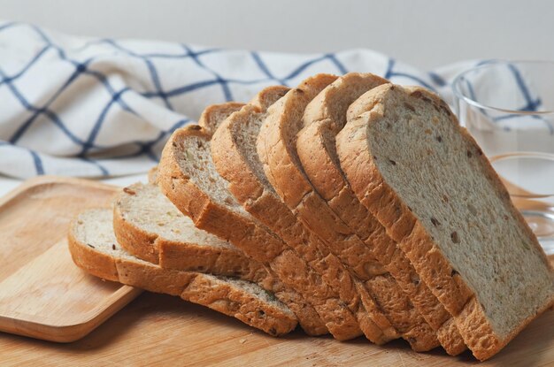 A loaf of bread on a cutting board with the word bread on it