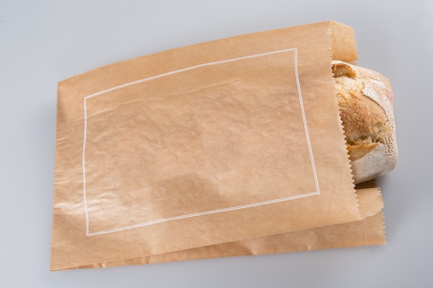 Photo loaf of bread in a grocey paper bag in european style