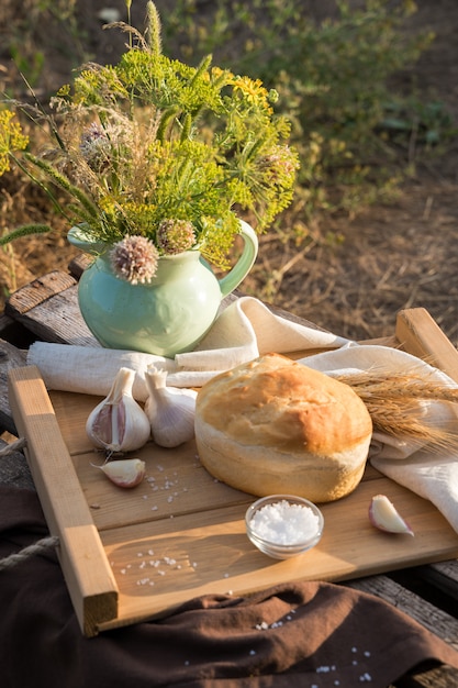 A loaf of bread and wheat in natural conditions in nature