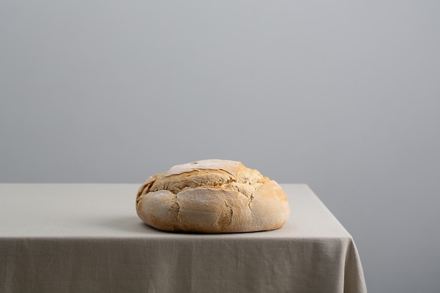 Loaf of bread on wooden background, food closeup