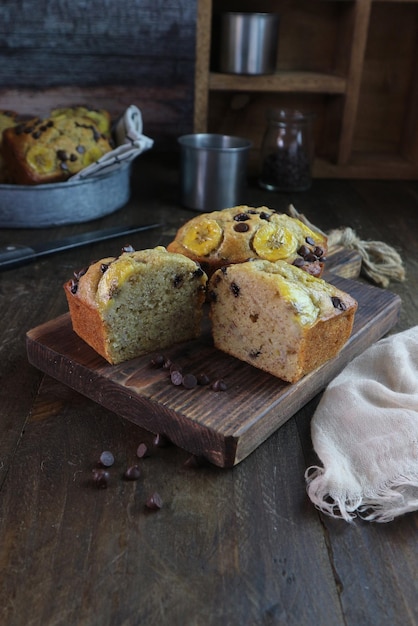 A loaf of chocolate chip muffins on a wooden board.