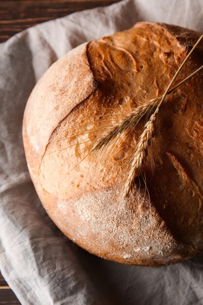 Loaf of fresh bread on table