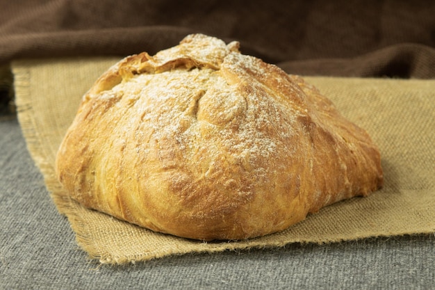 A loaf of freshly baked bread on a towel