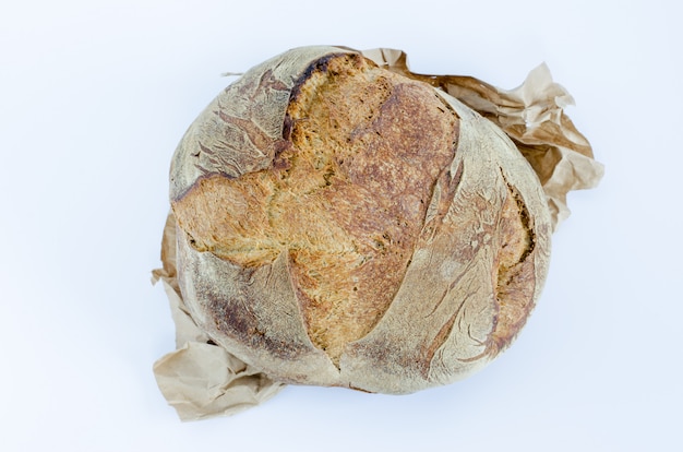 Photo loaf of rustic bread on white