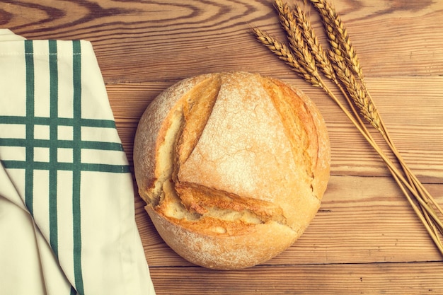 A loaf of traditional bread on a wooden table