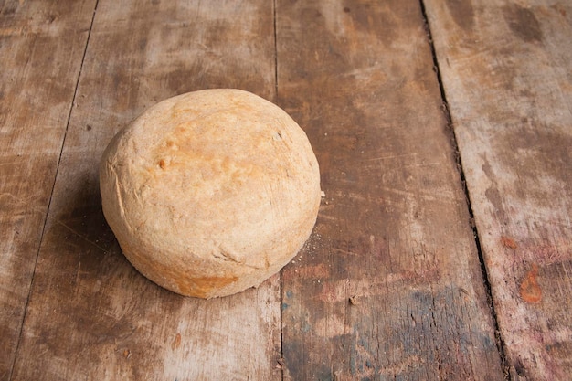 Loaf of white bread on a wooden table