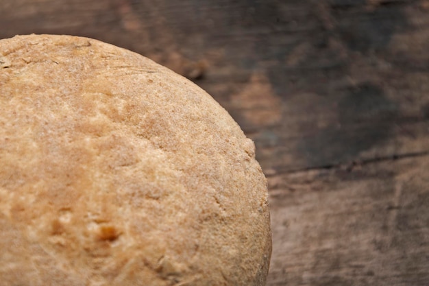 Loaf of white bread on a wooden table