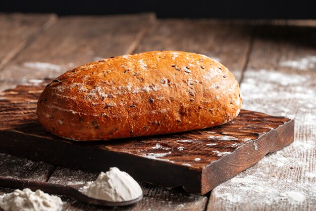 Loaf of white wheat bread on a wooden board