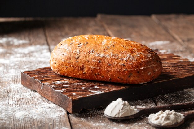 Loaf of white wheat bread on a wooden board