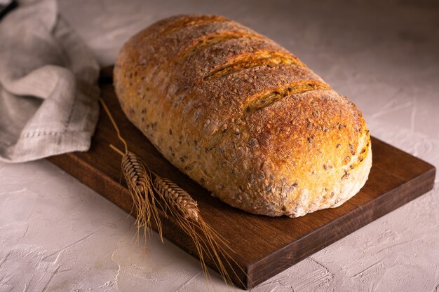 Loaf of whole grain homemade bread and wheat