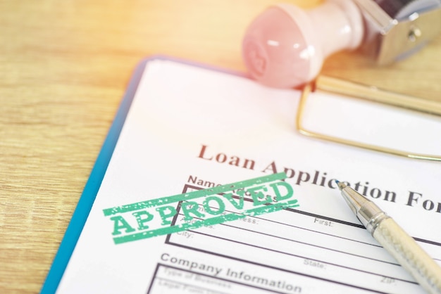 Loan application form with Rubber stamping that says Loan Approved, Financial loan approval