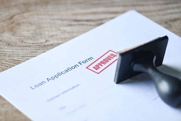 Loan approved on loan application form paper with rubber stamp on table Loan approval business finance economy concept