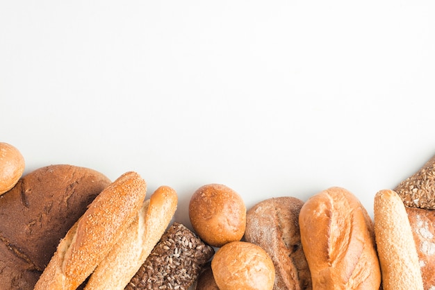 Loaves of baked breads on white backdrop