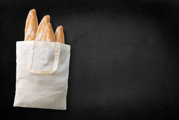 loaves of bread on dark board, top view free text space.