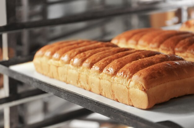 Loaves of bread on shelving in bakery