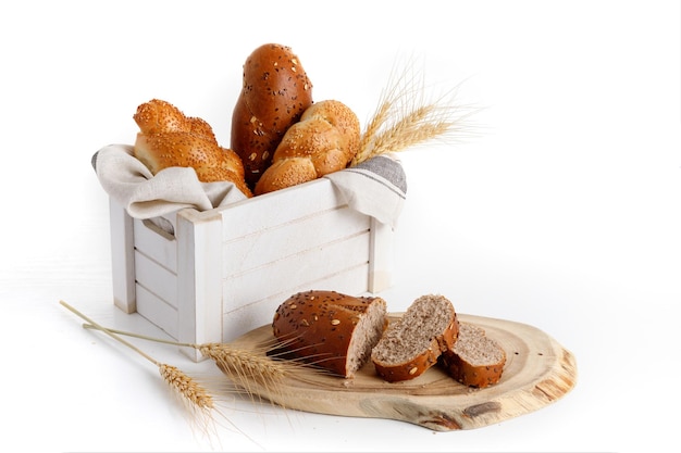 Loaves of bread in a white wooden box wheat ears