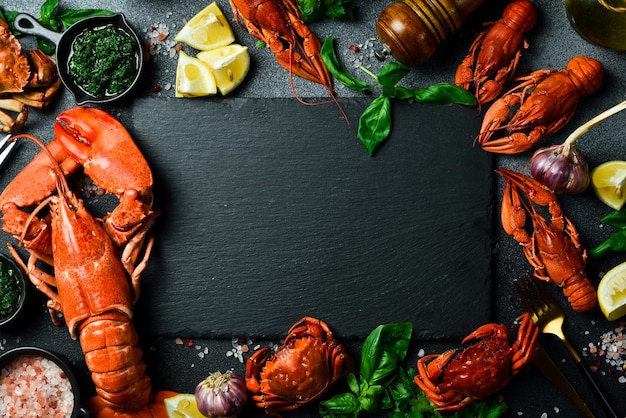 Lobster banner free space for text grilled lobster crab and crayfish with lemon and basil on a black slate board
