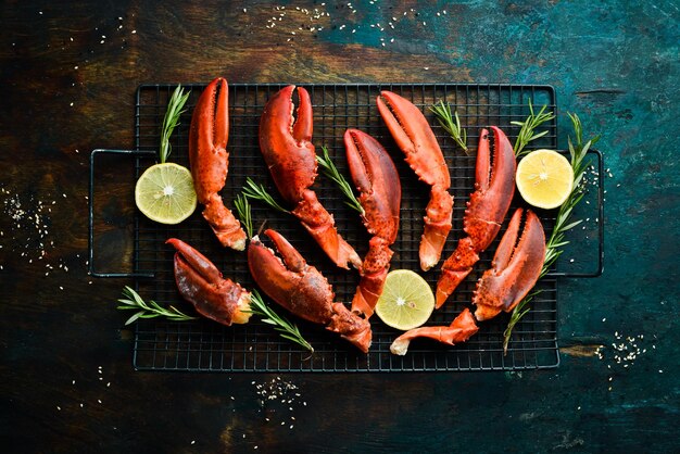 Lobster claws Boiled crustacean claws on a black stone background Rustic style